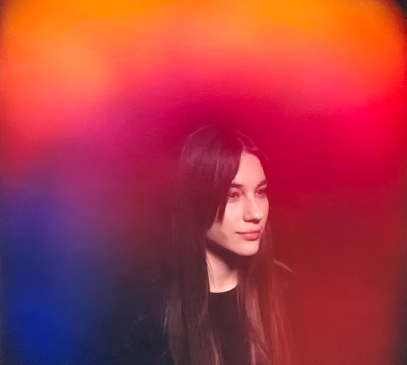 A single aura portrait with vibrant red, orange, and blue energy bands